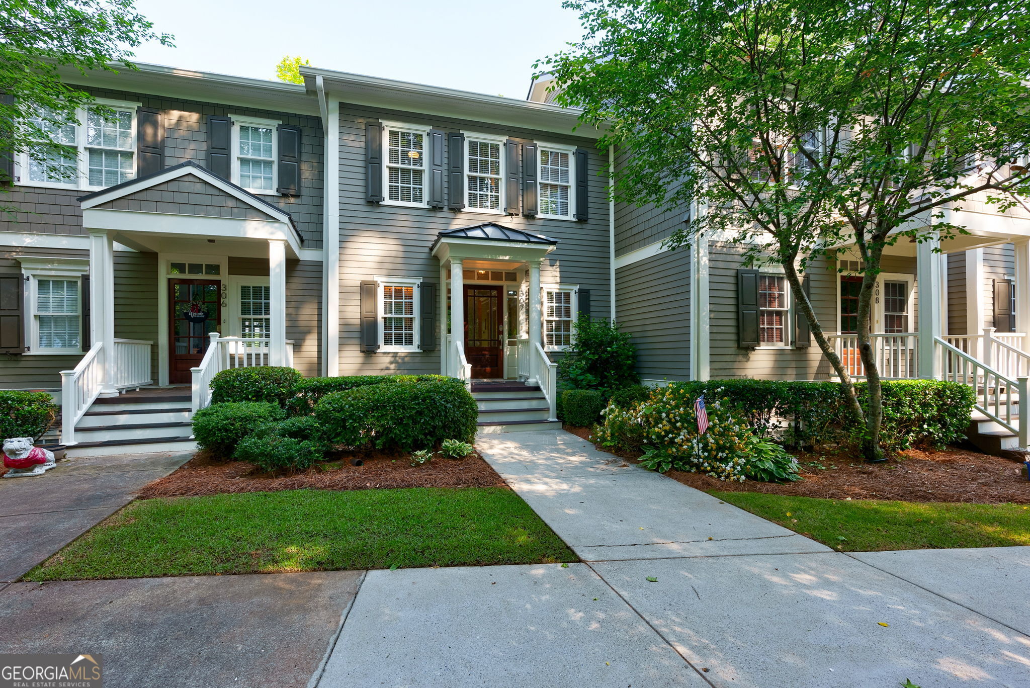 front view of a brick house with a yard