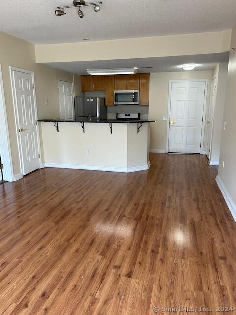 a view of a kitchen with a sink and wooden floor