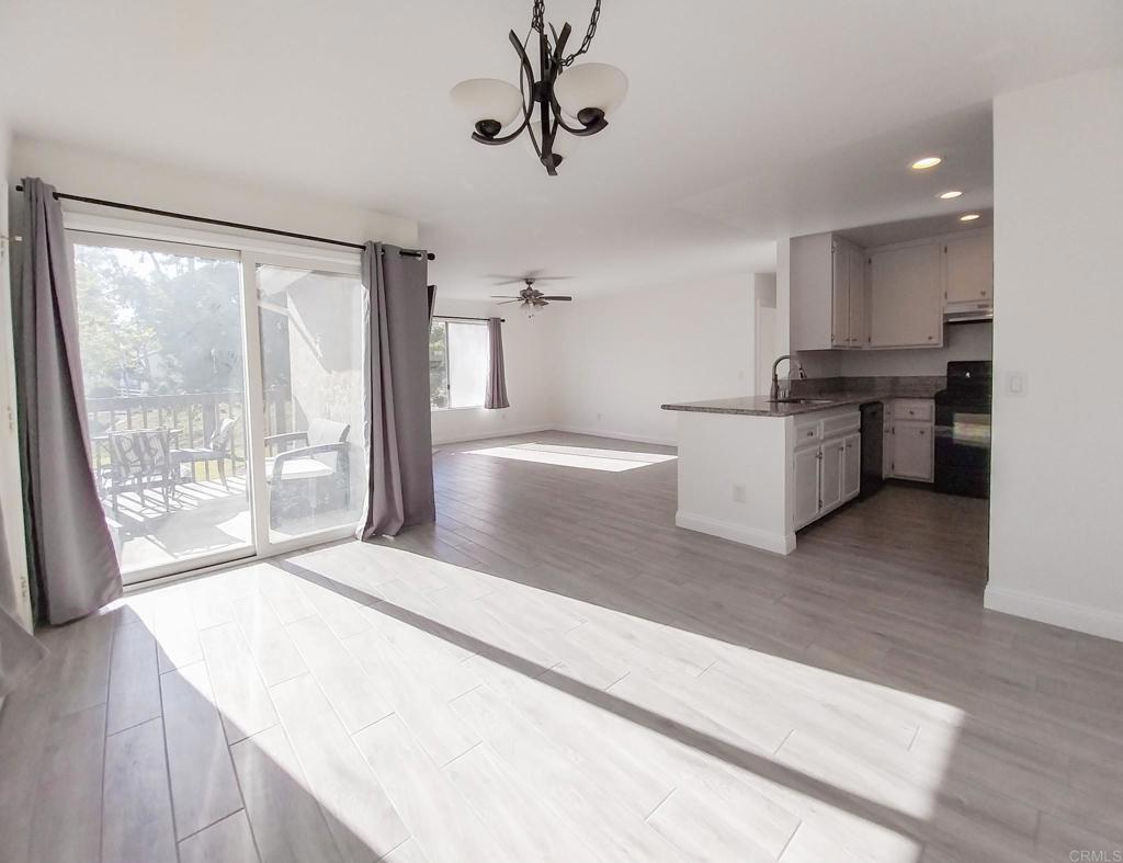 a large white kitchen with a large window