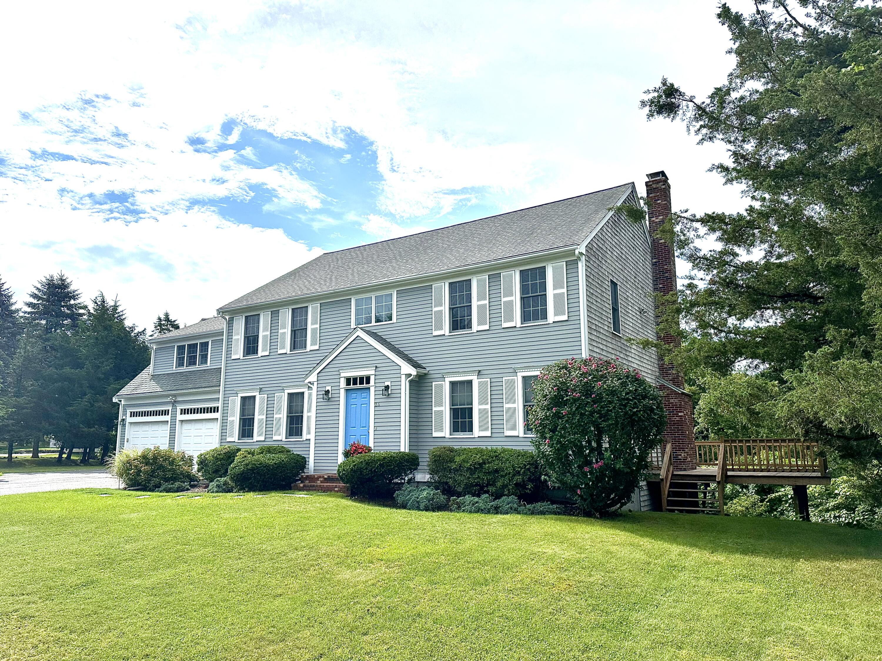 a view of a house with a yard and sitting area