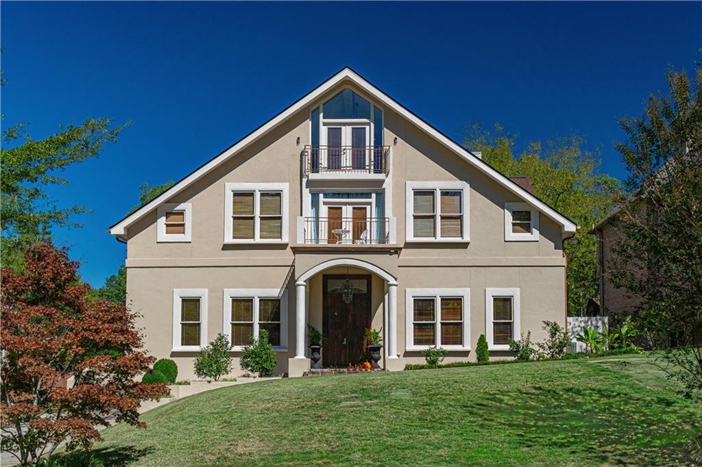 a front view of a house with a garden