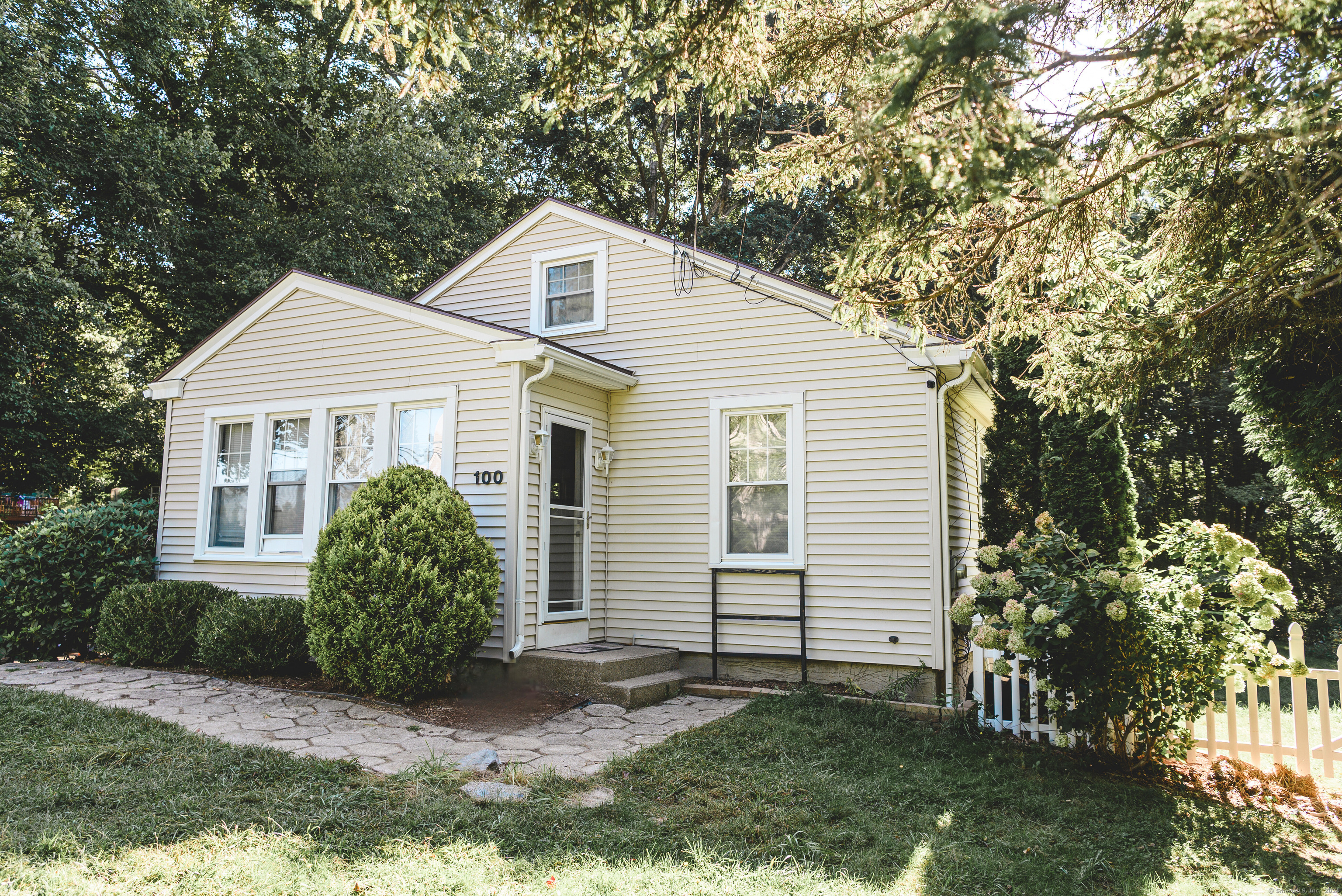 a view of a house with a yard and plants