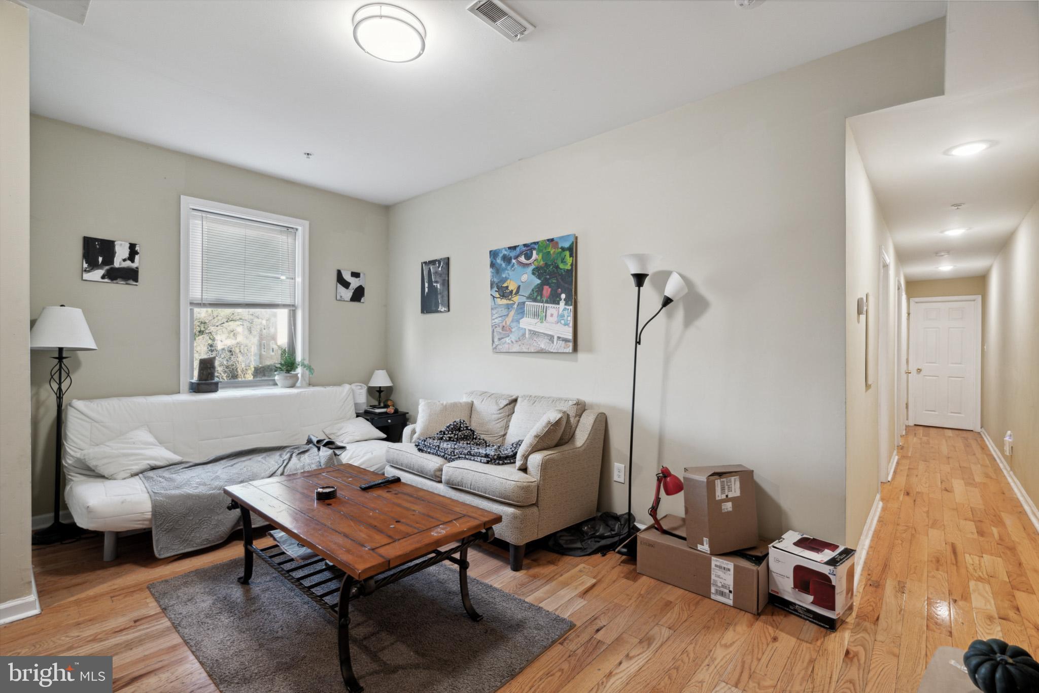 a living room with furniture a rug and a lamp