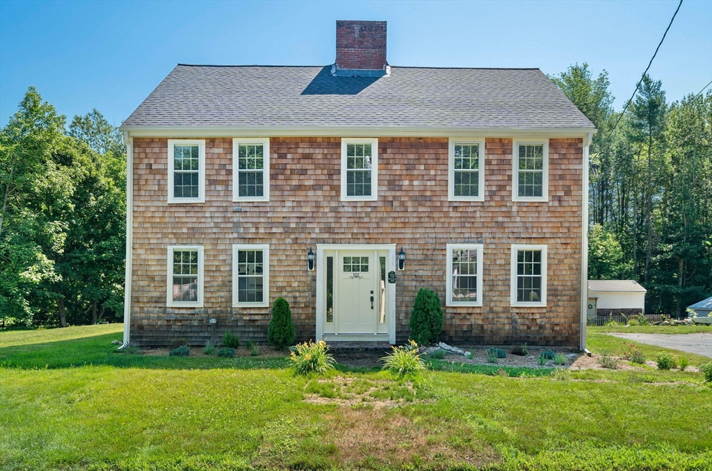 a front view of a house with a yard