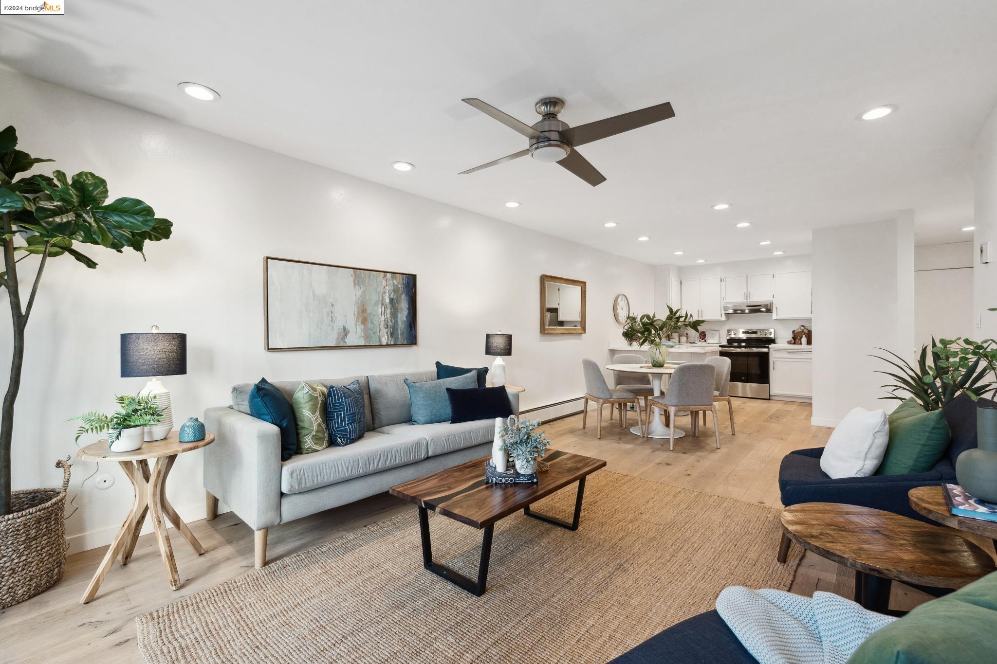 a living room with furniture and a potted plant