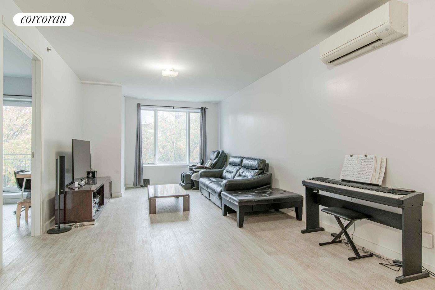 a living room with furniture a rug and a window