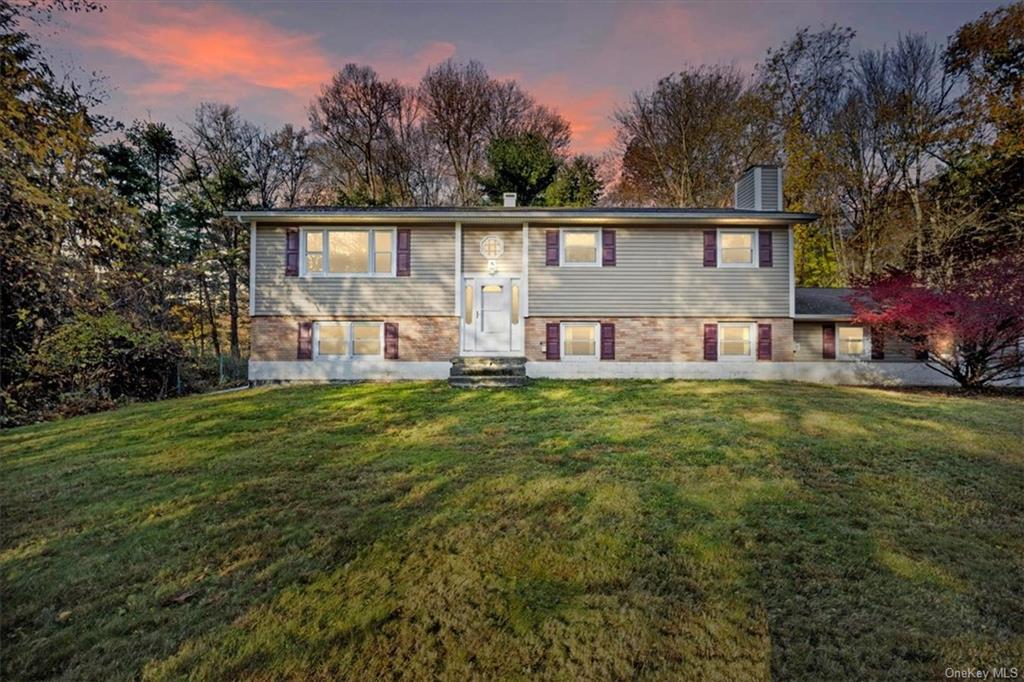 Split foyer home with a lawn