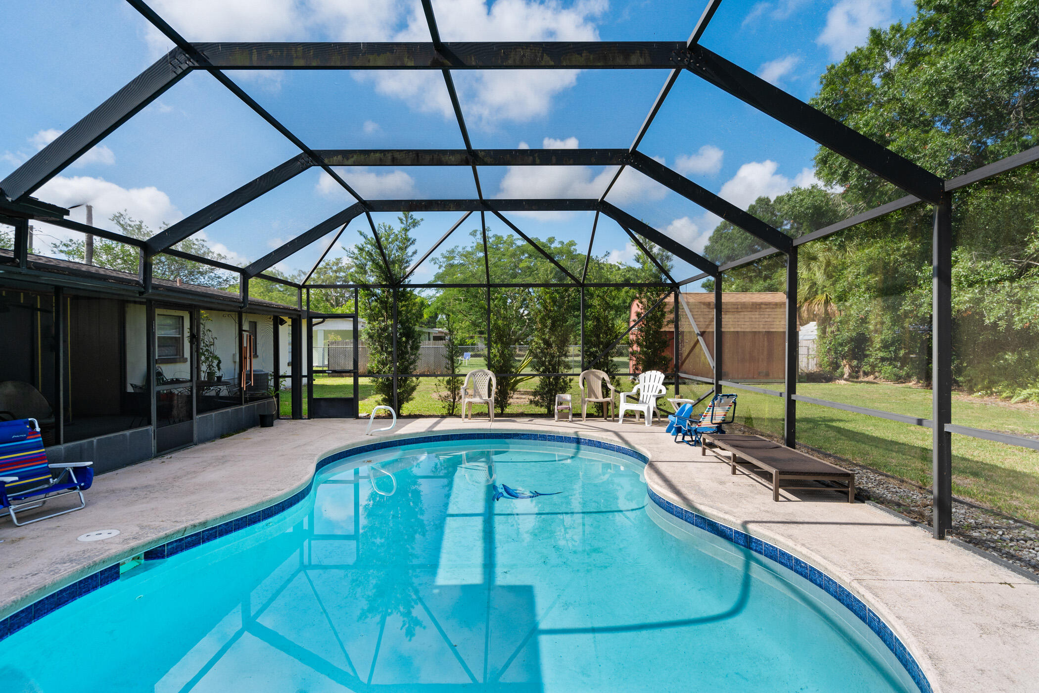 a swimming pool with patio outdoor seating and yard