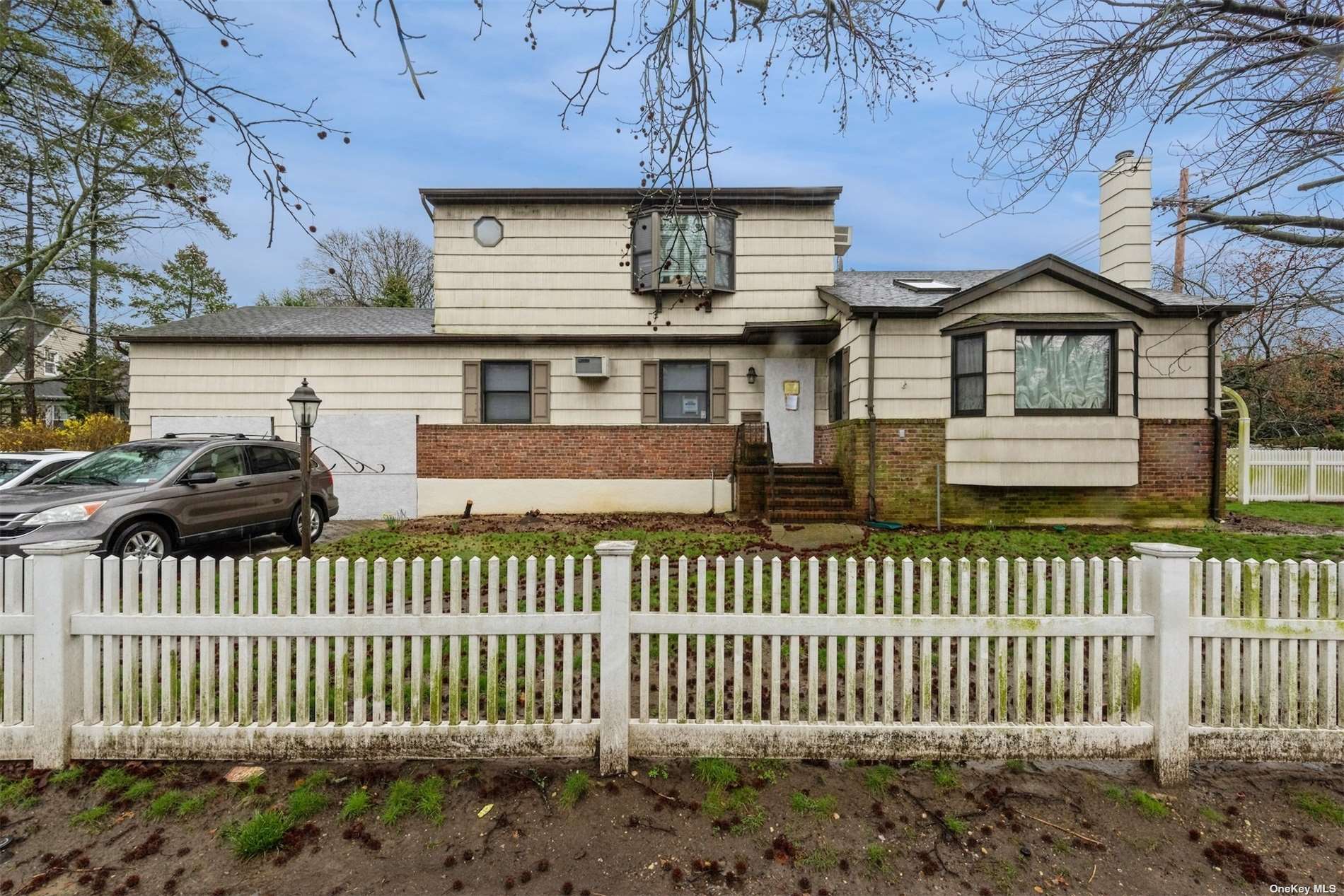 a front view of a house with a garden