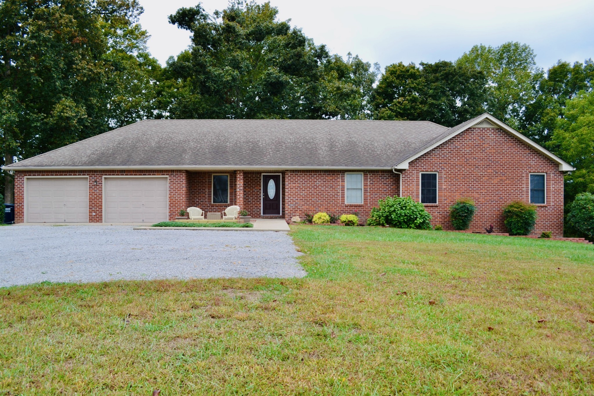 a front view of a house with a garden