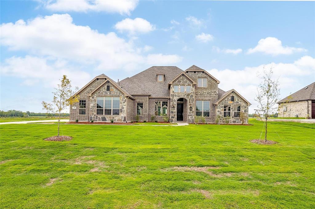 a front view of a house with a big yard