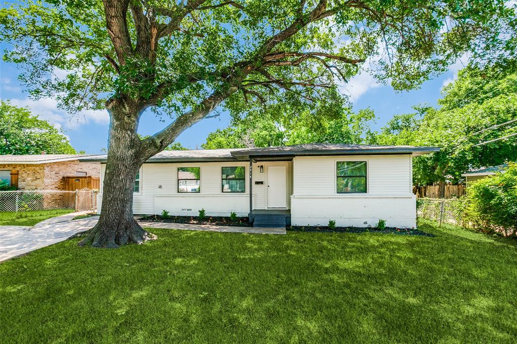 a front view of house with yard and trees