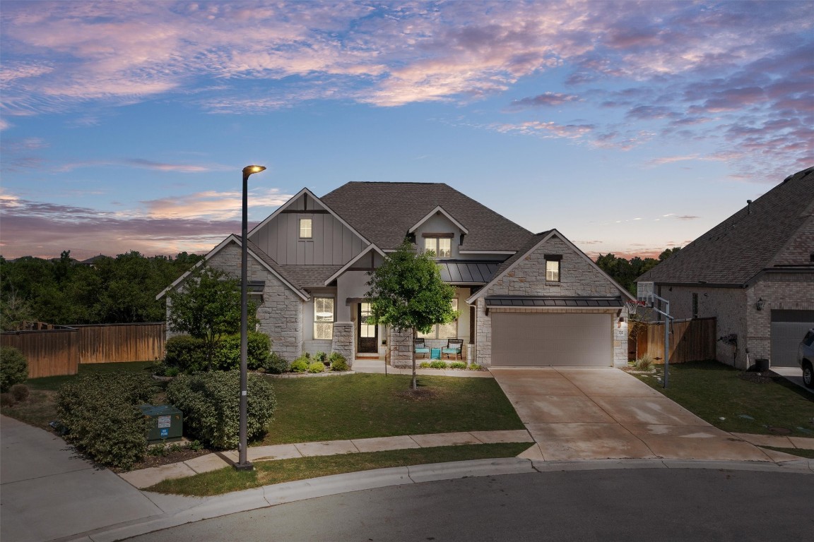 a front view of a house with a garden