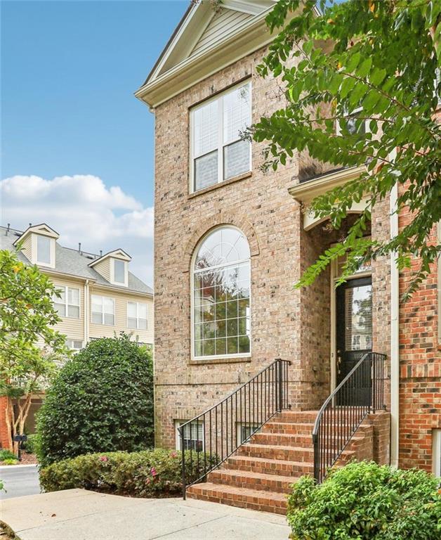 a front view of a house with a tree