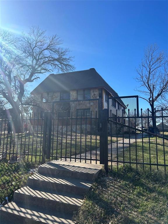 a view of a brick building next to a yard