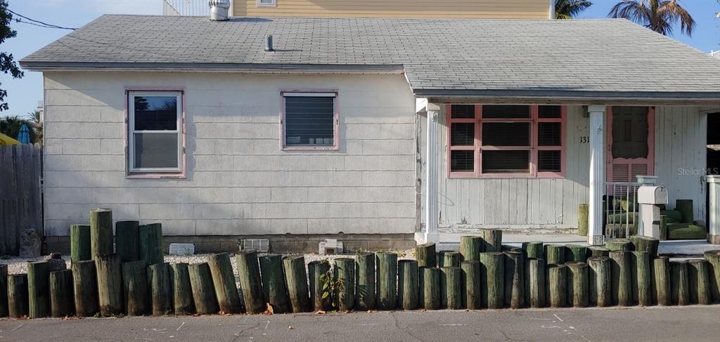 a view of a house with a wooden fence