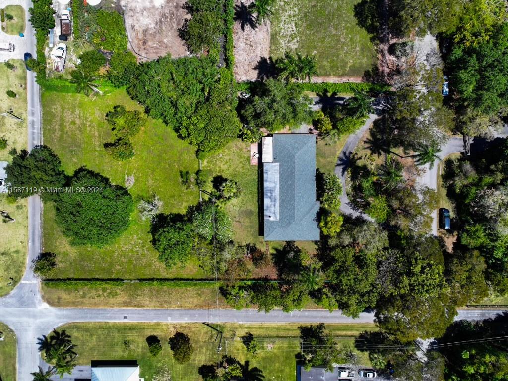 an aerial view of a house with a yard