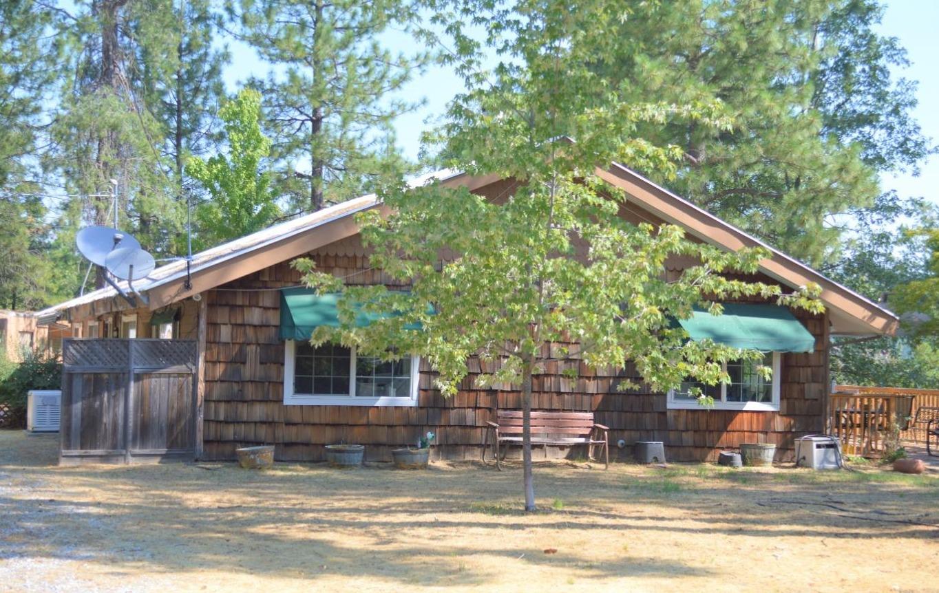 a view of a house with backyard and sitting area