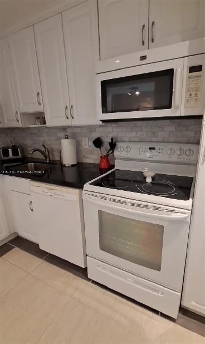 a kitchen with microwave cabinets and stainless steel appliances