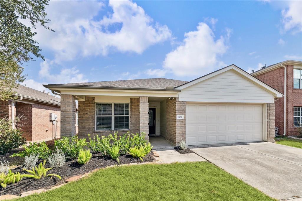 Welcome home! This charming property features an inviting, covered front patio perfect for relaxing, framed by vibrant landscaping that adds warmth and curb appeal.