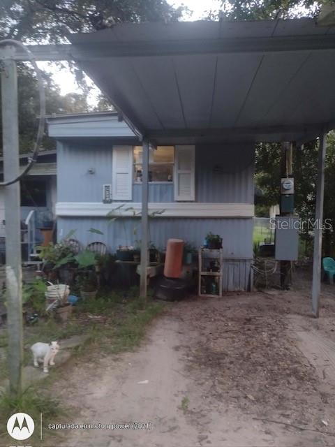 a view of a chairs and table in backyard of the house