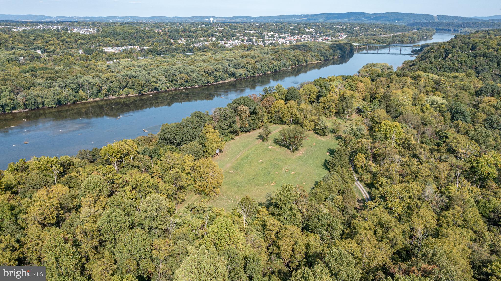 an aerial view of residential houses with outdoor space and lake view