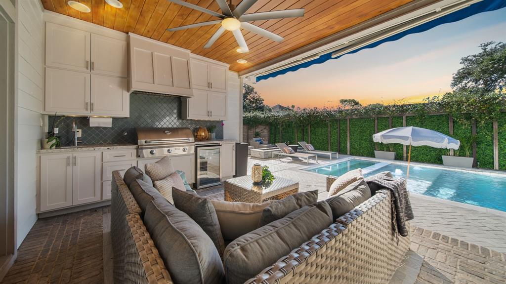 a view of kitchen with stainless steel appliances kitchen island granite countertop a table and chairs