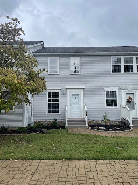 a front view of a house with a yard