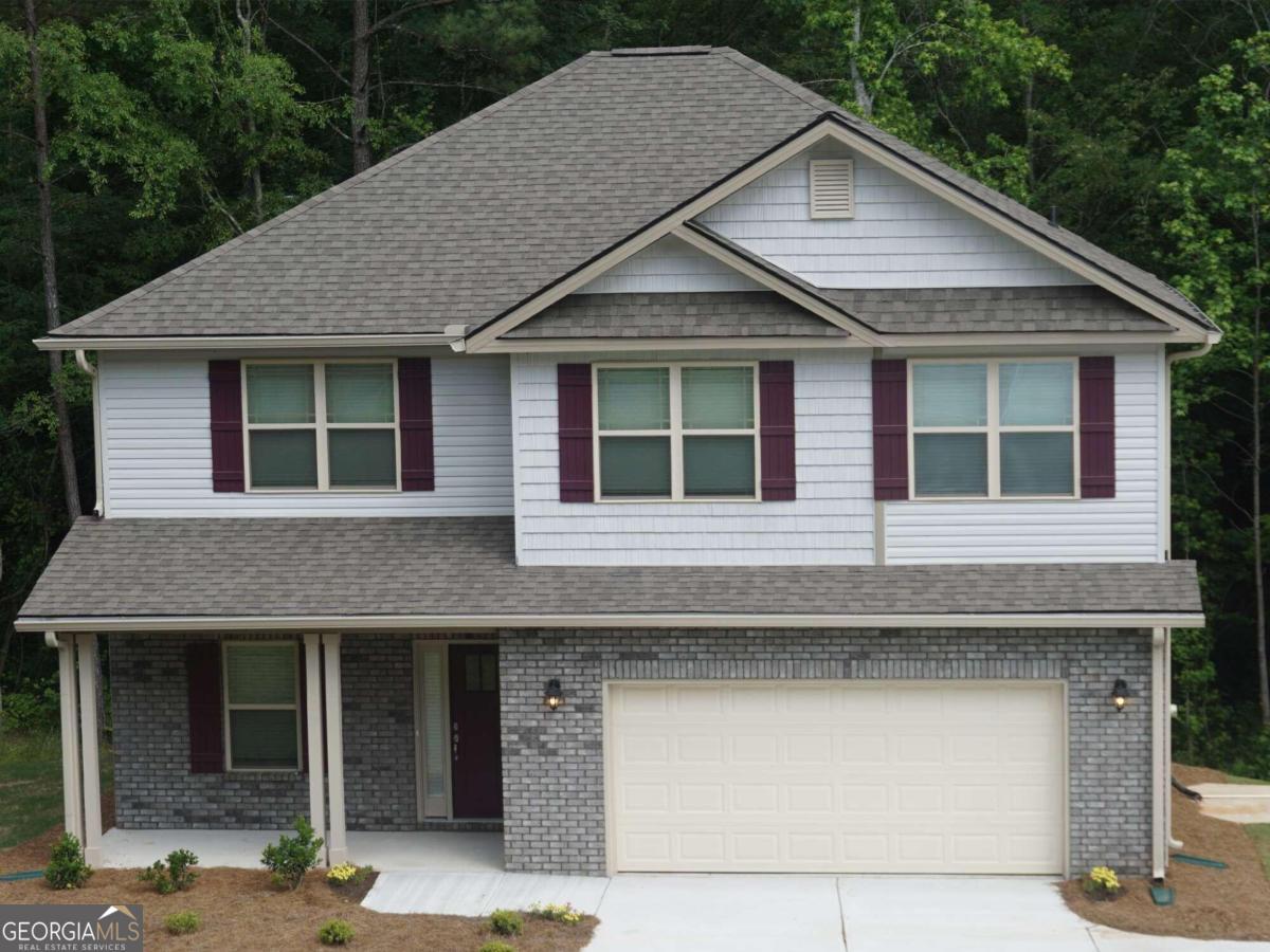 a front view of a house with garage