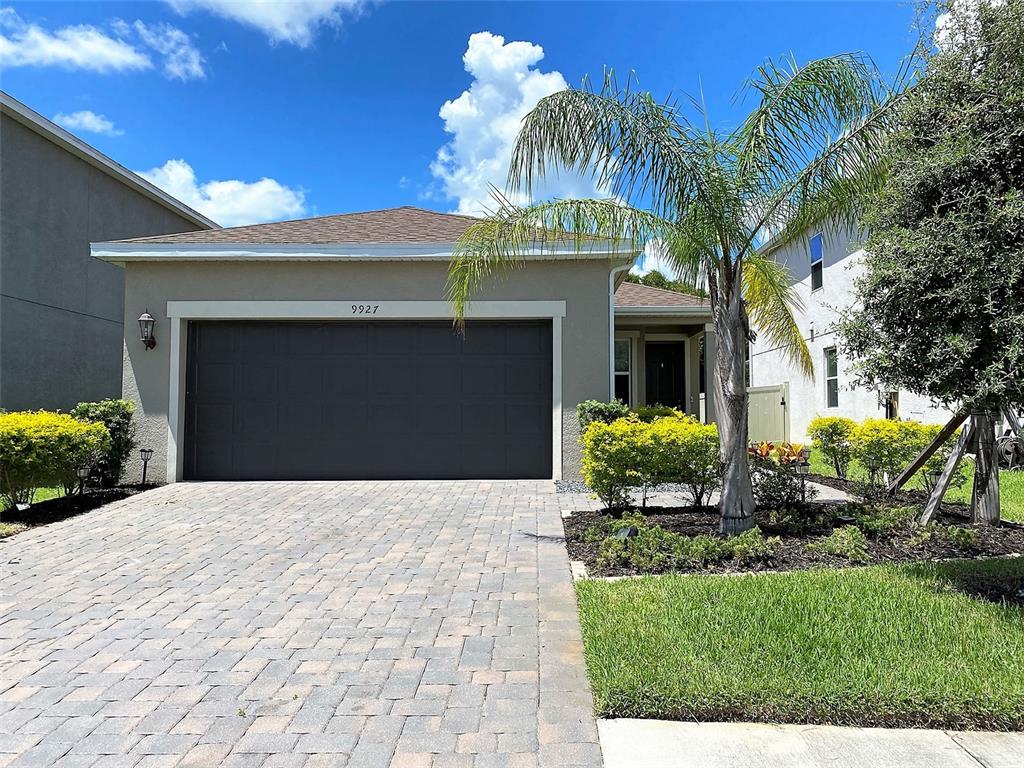 a front view of a house with a yard and garage