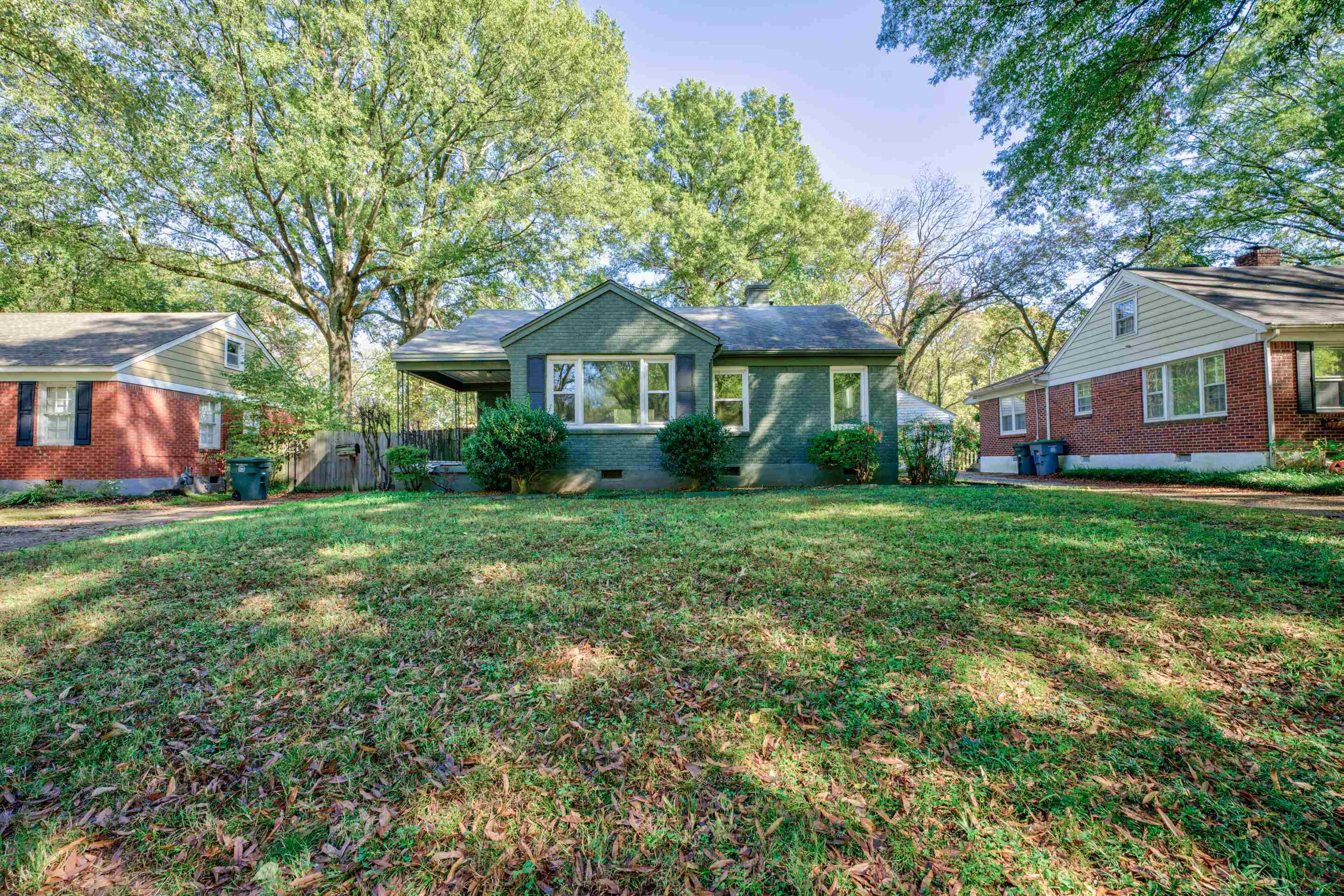 a front view of house with yard and green space