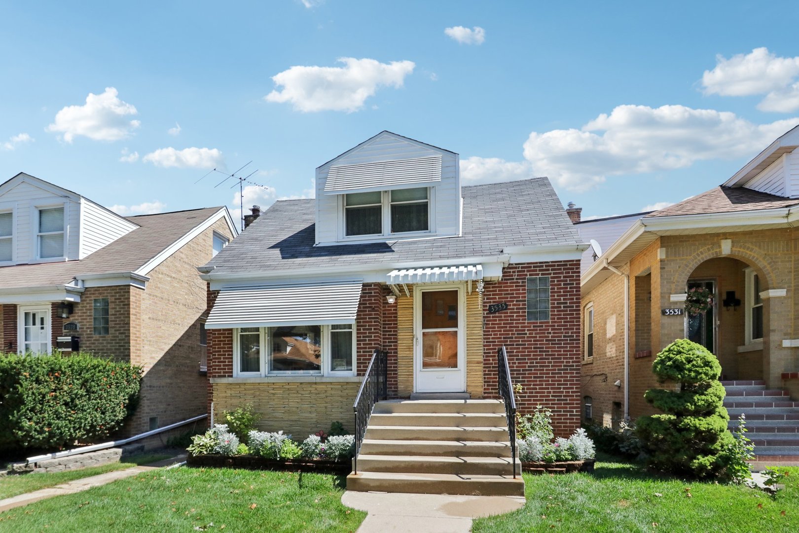 a front view of a house with a yard