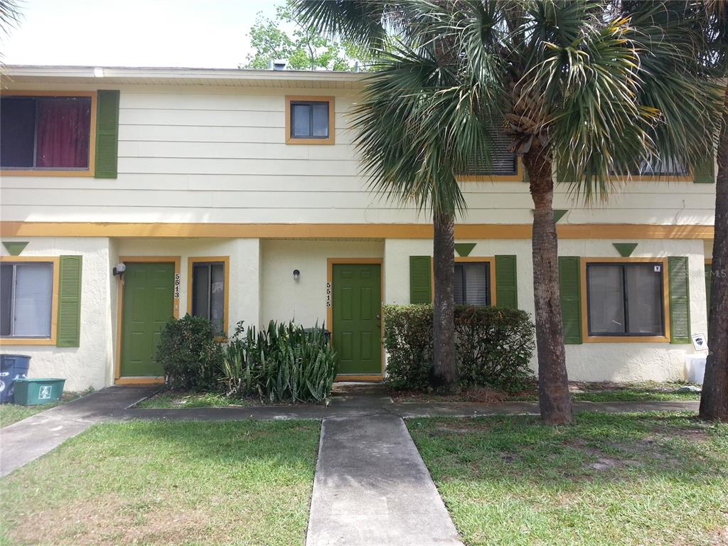 a front view of house with yard and green space