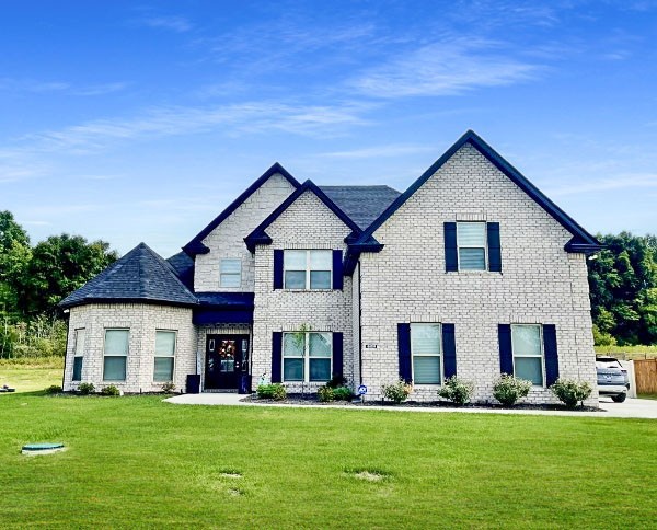 a front view of a house with a yard