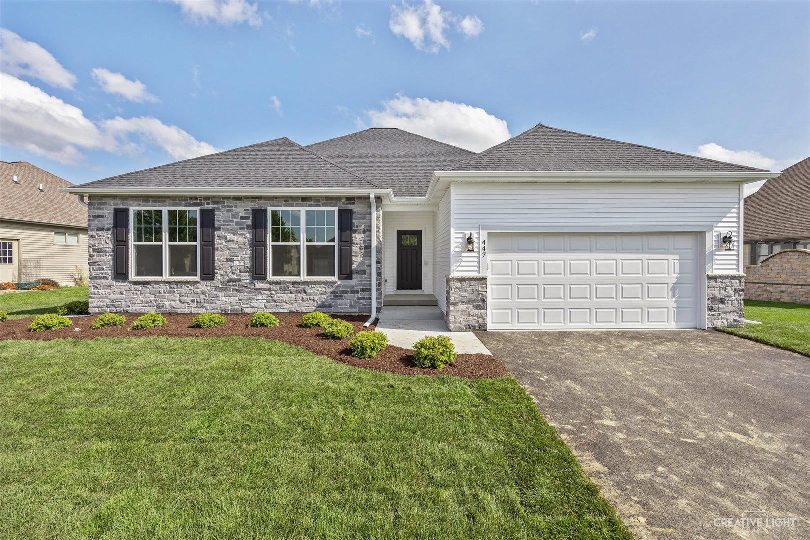 a front view of a house with a yard and garage