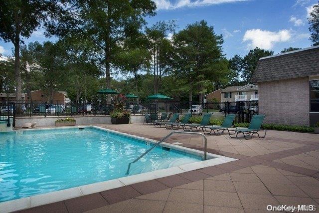 a swimming pool with outdoor seating and yard