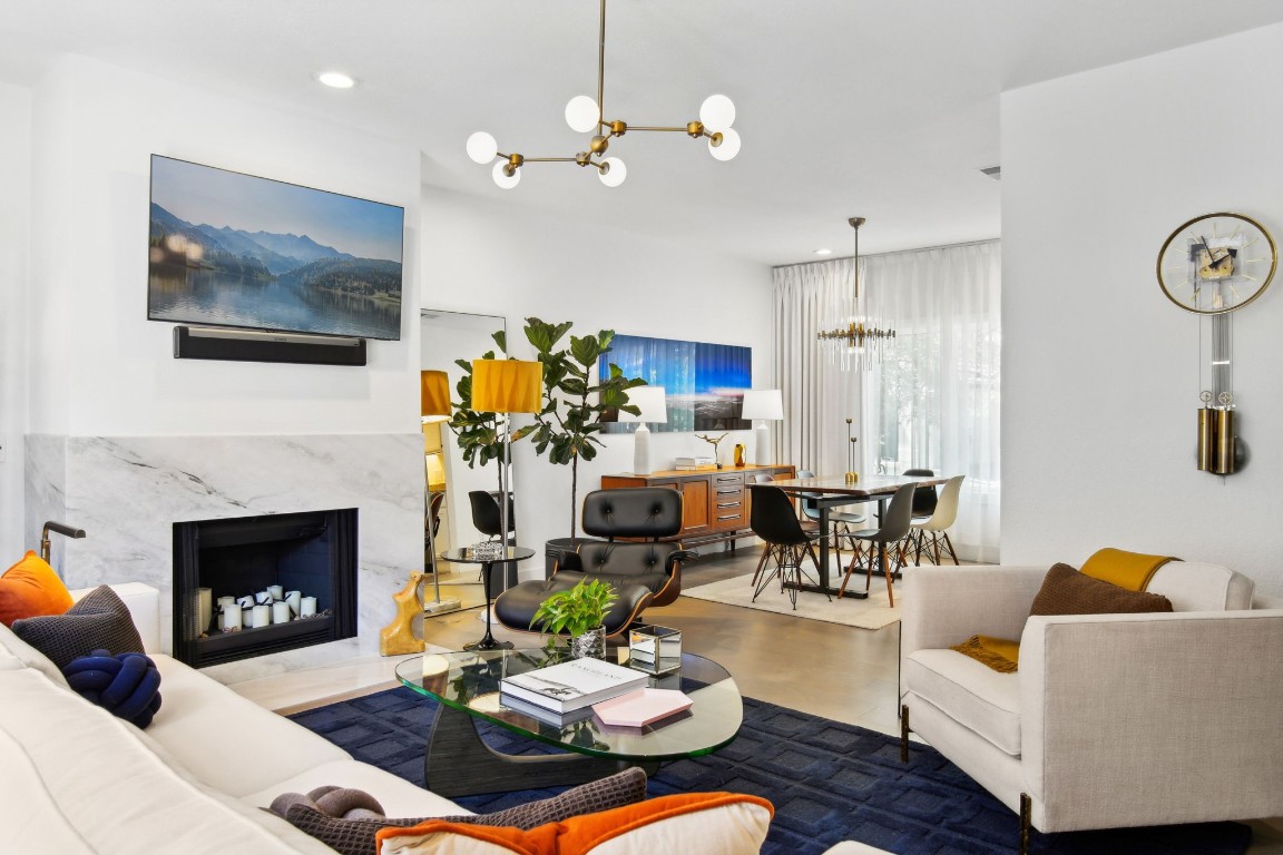 a living room with furniture a fireplace and a flat screen tv