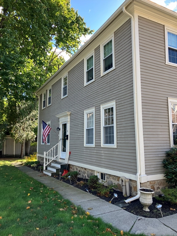 a view of a house with a yard and a garage