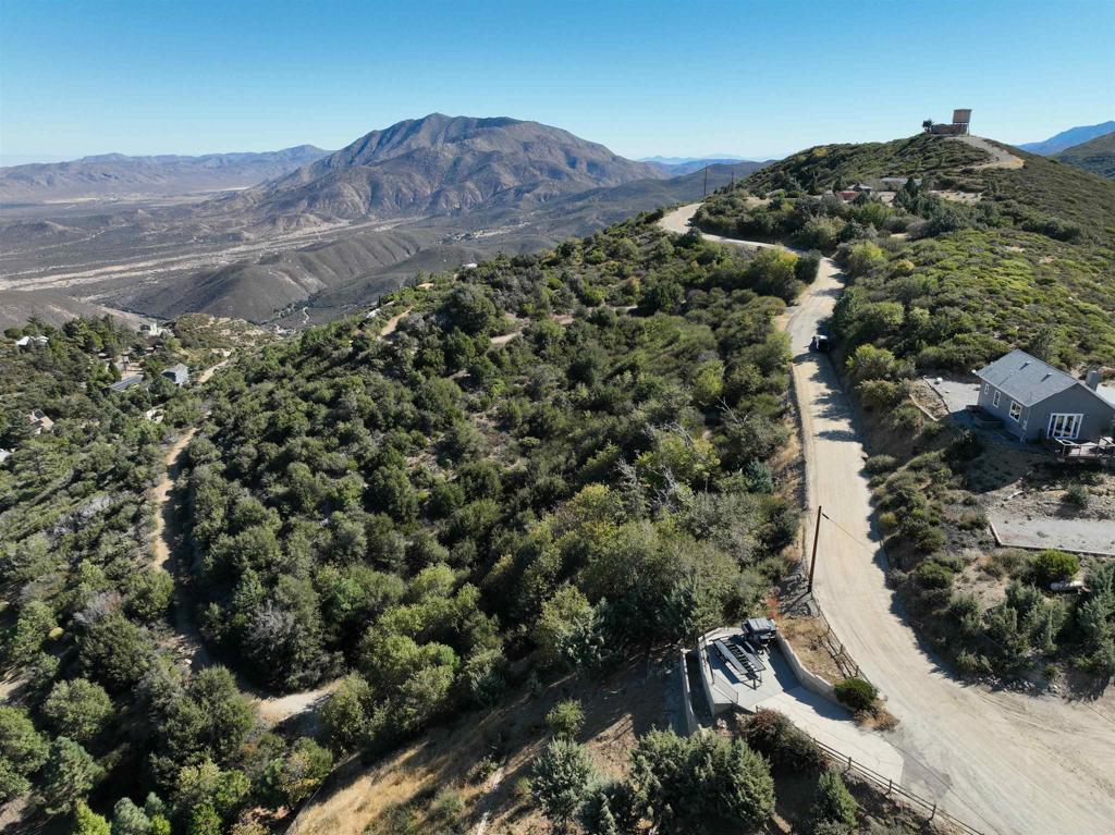 an aerial view of residential house and car parked