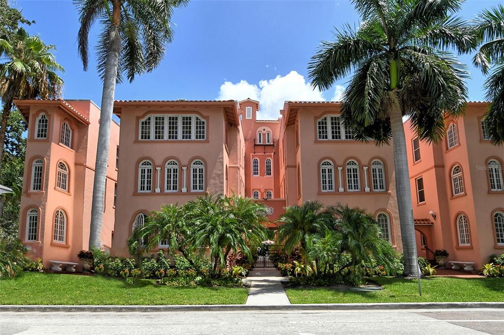 a front view of multiple houses with yard