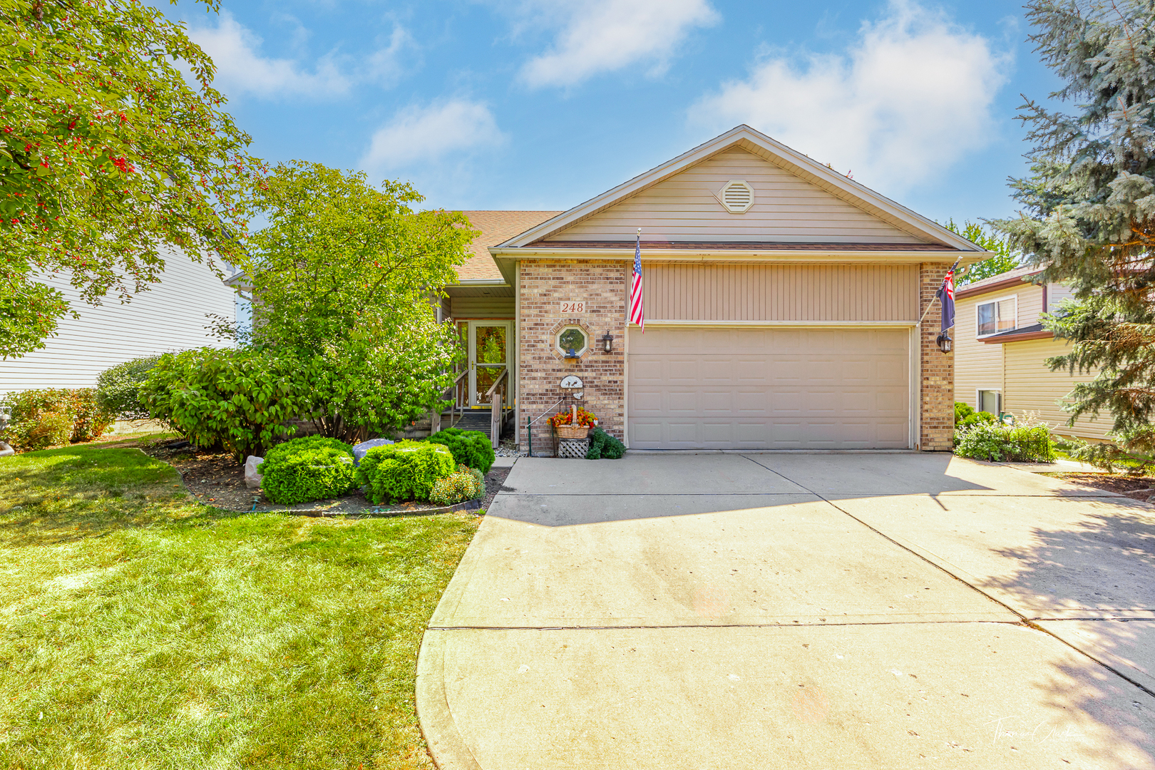 a front view of a house with a yard and garage