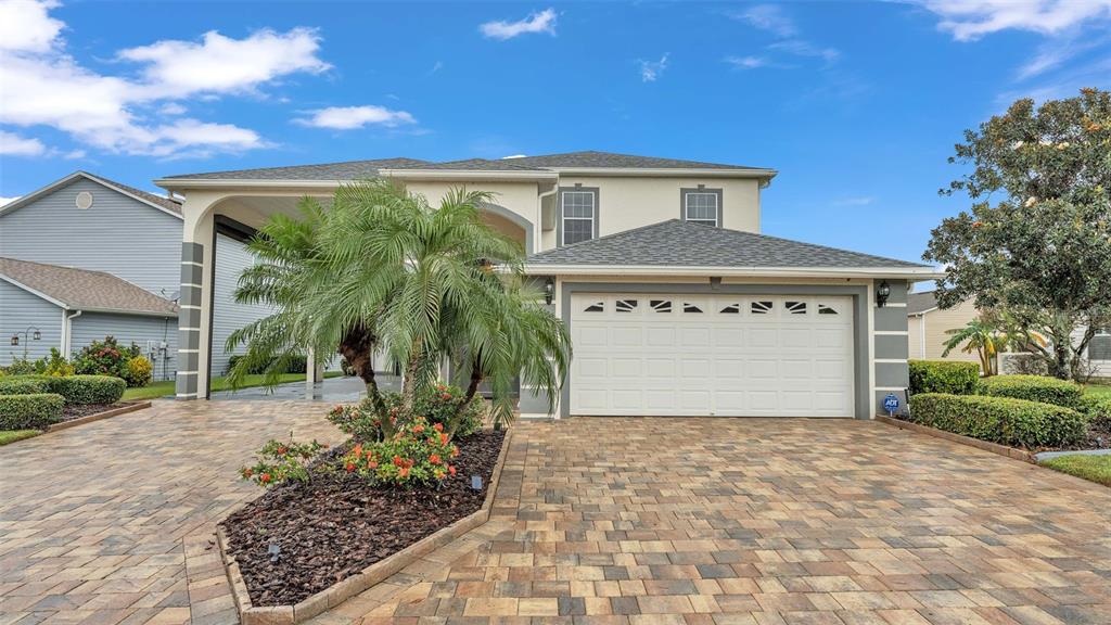 a front view of a house with a yard and garage