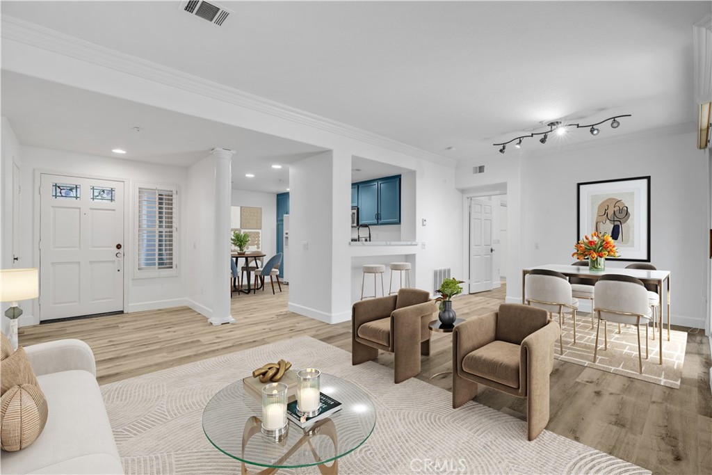 a living room with furniture and a wooden floor