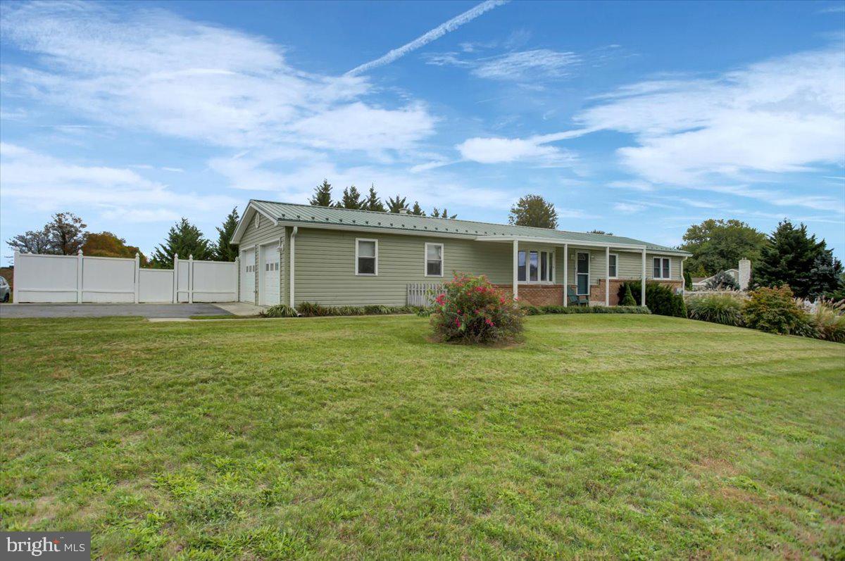 a view of an house with backyard space and garden