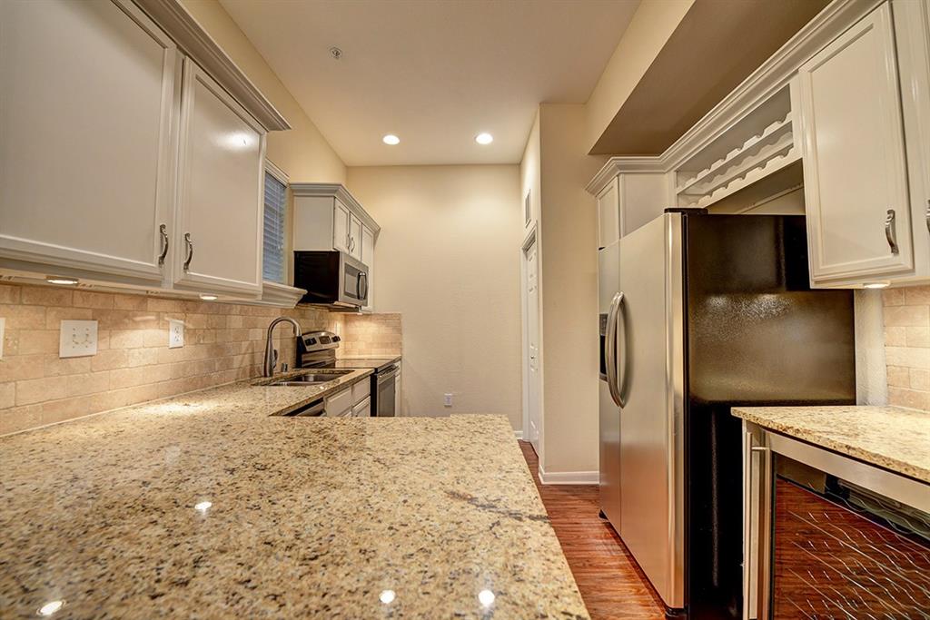 a kitchen with stainless steel appliances wooden cabinets a sink and a stove