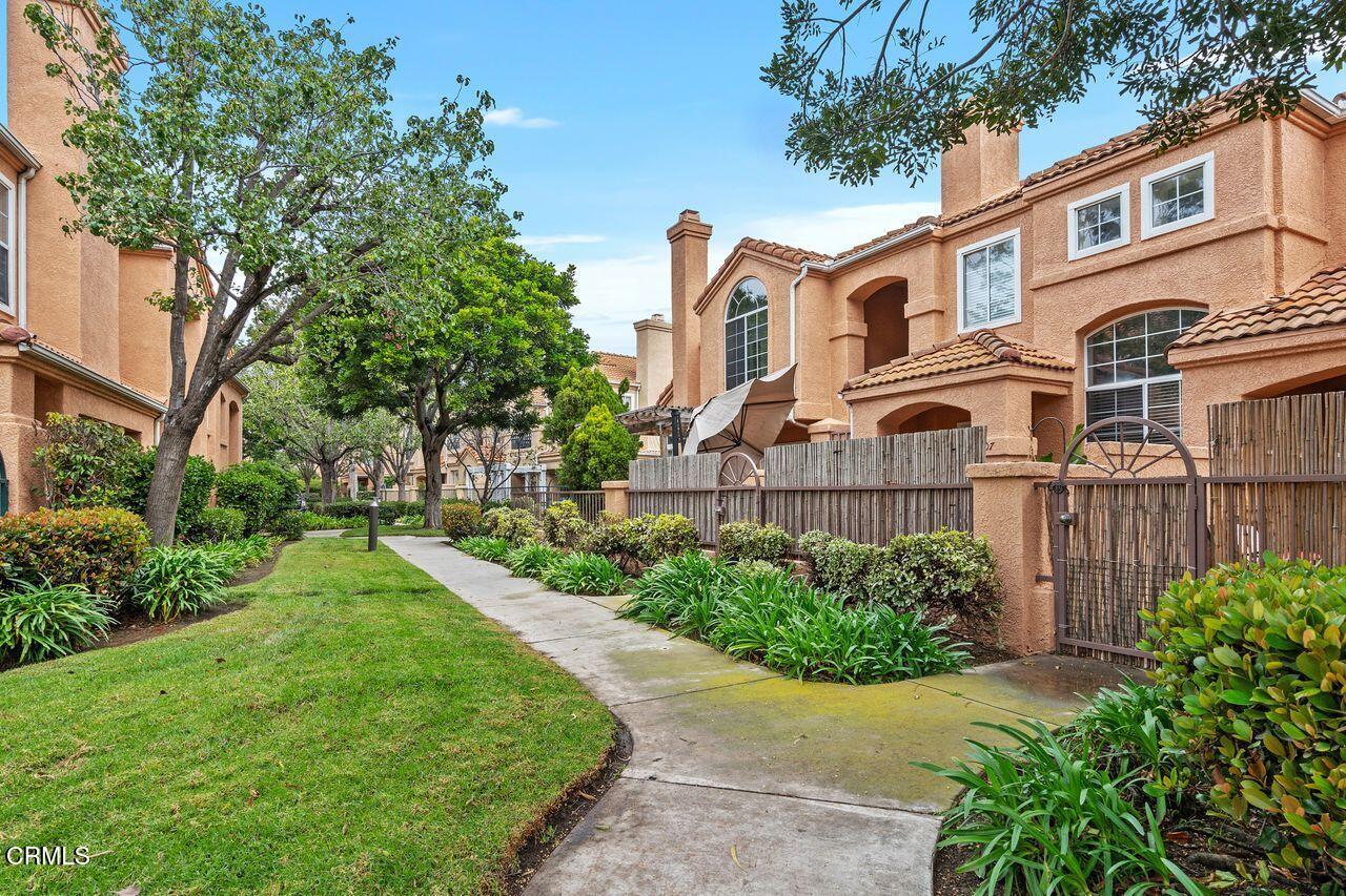 a front view of a residential houses with yard and green space