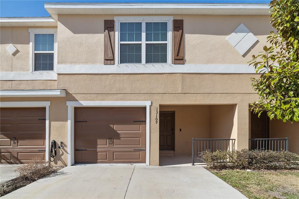 a front view of a house with a yard and garage