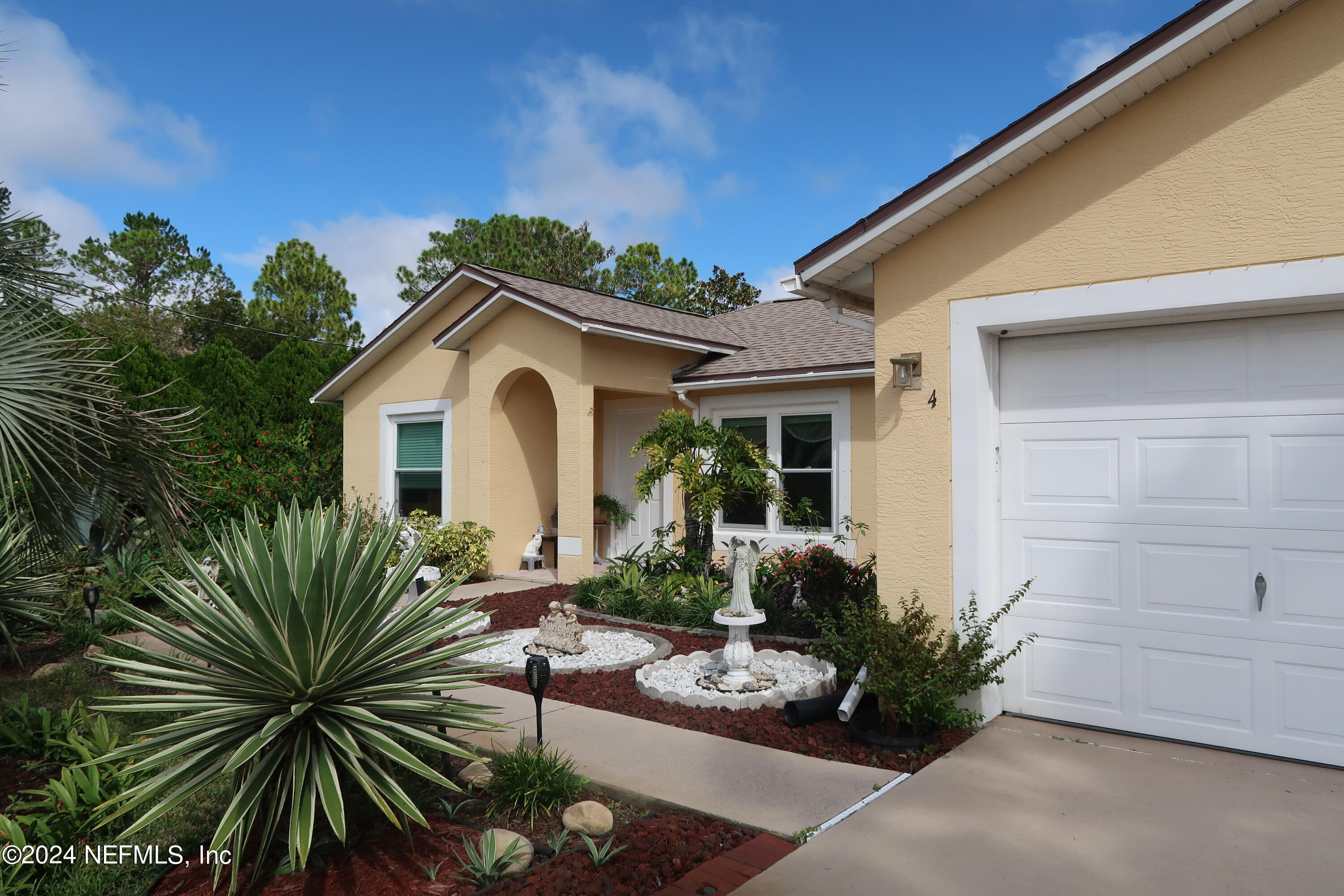 a view of a house with patio outdoor seating and plants