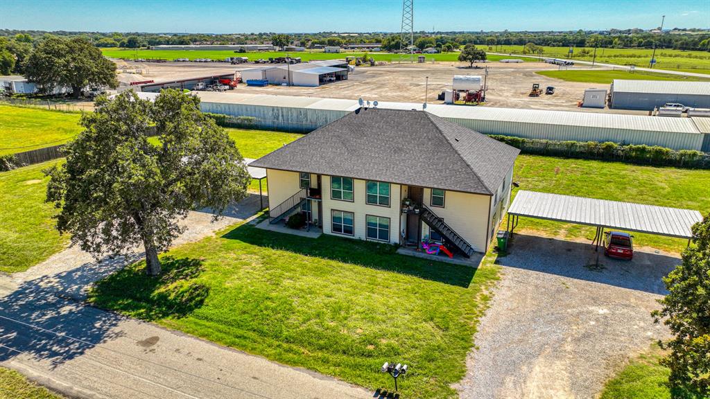 an aerial view of a house with a swimming pool patio and outdoor seating