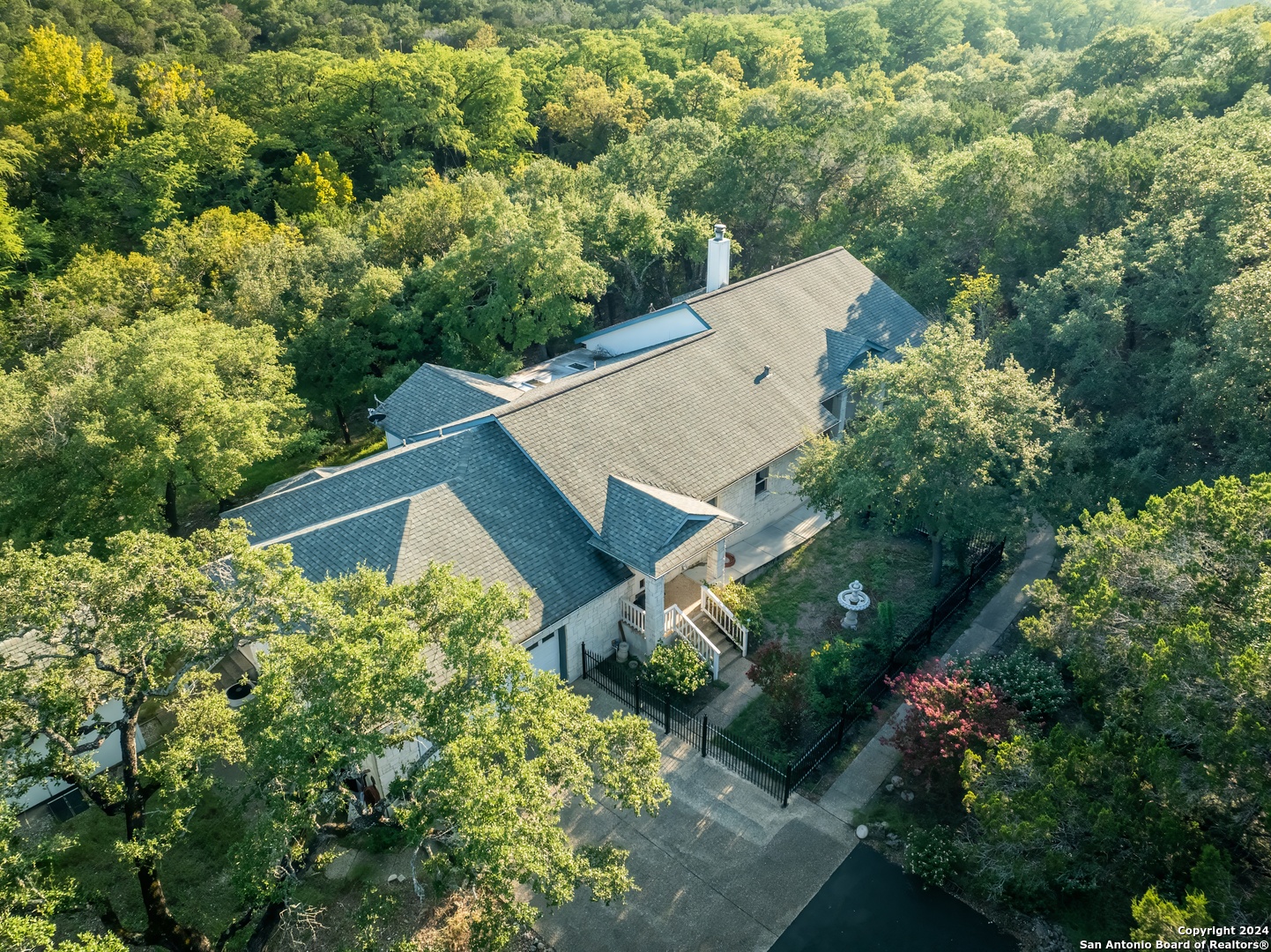 an aerial view of a house with a yard